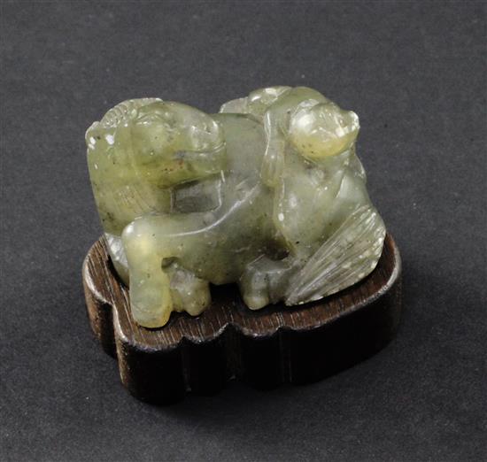 A Chinese green soapstone carving of a monkey climbing on a recumbent horse, 19th century, 4.5cm, wood stand